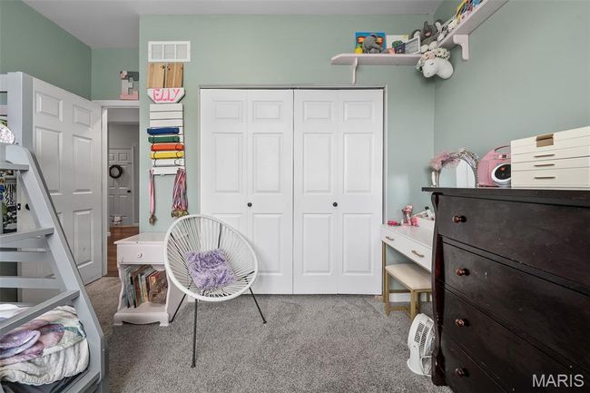 Carpeted bedroom with a closet | Image 21