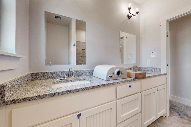 Full bath with tiled shower, double vanity, and a sink | Image 30