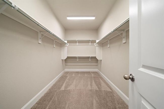 Large primary closet that has pleny of storage space! | Image 21