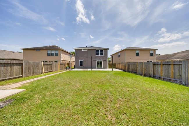 The yard is a blank canvas, ready for the new owner to create their perfect outdoor oasis. | Image 34