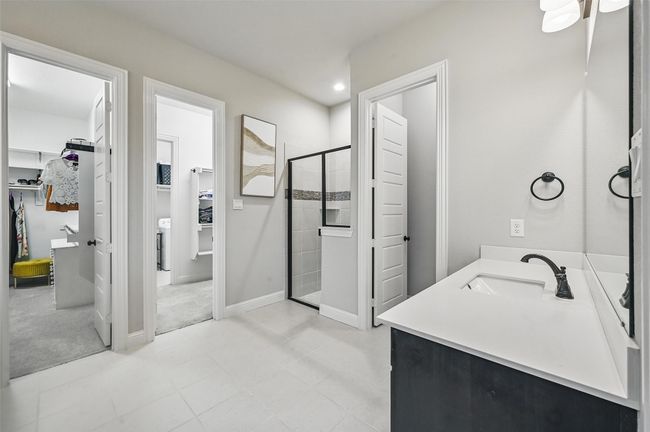 Bathroom with a spacious closet, vanity, a stall shower, and recessed lighting | Image 28