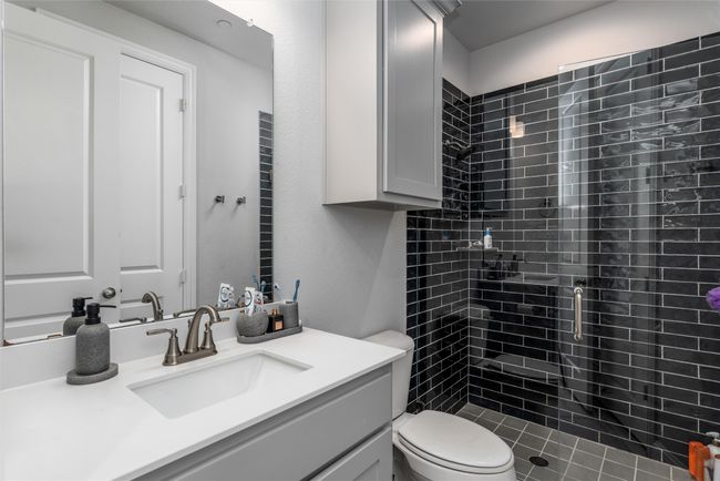 Bathroom with vanity, toilet, and a stall shower | Image 25