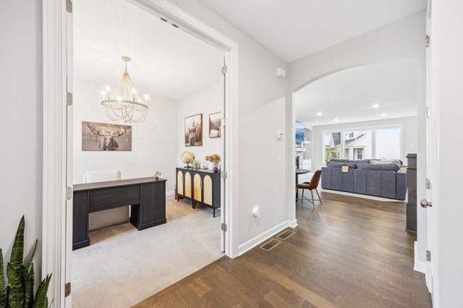The office with french doors and showing the view into the living room area from the front door entrance. | Image 14