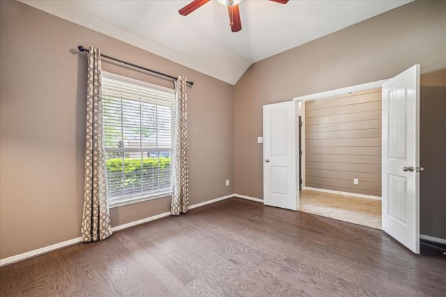 Versatile flex space with stylish sconces, built-in shelving, and ample natural light—ideal for a home office or creative studio. | Image 12