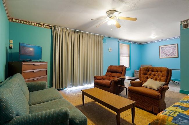Tiled living area featuring ceiling fan | Image 17