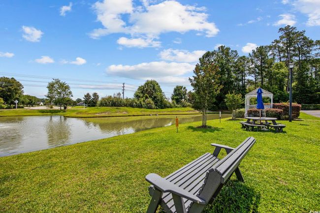 View of community featuring a water view, a gazebo, and a lawn | Image 28