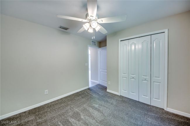 Unfurnished bedroom featuring carpet floors, visible vents, and baseboards | Image 42