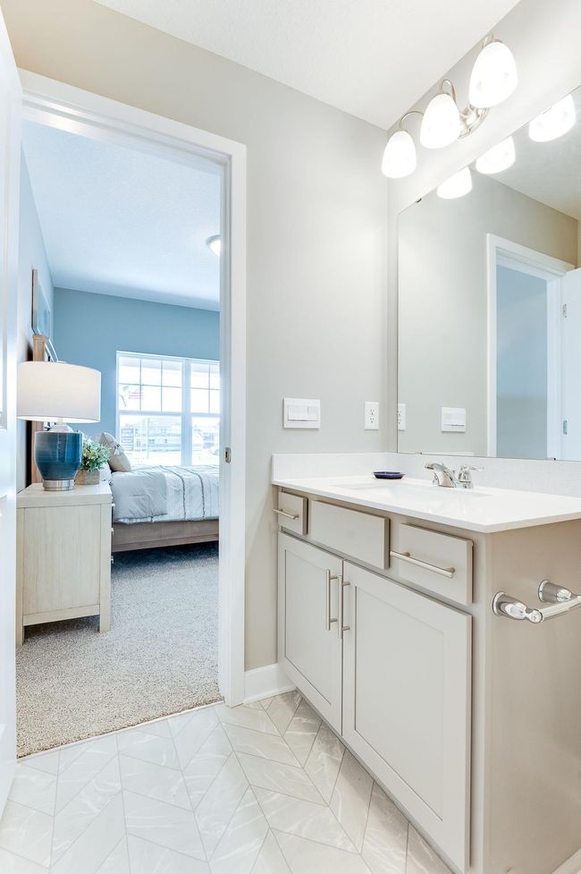 A different view point of main level bed and bathroom. Photo of model home, color and options will vary. | Image 8