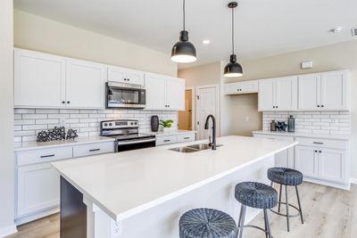 Kitchen with white cabinets, appliances with stainless steel finishes, and sink | Image 3