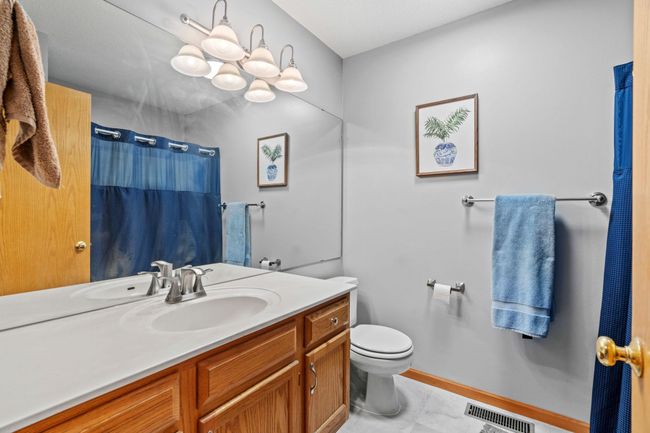 Full upper-level bath with large mirror, and plenty of cabinet storage. | Image 23