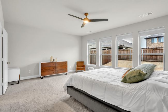 Bedroom featuring baseboards, carpet floors, visible vents, and ceiling fan | Image 14