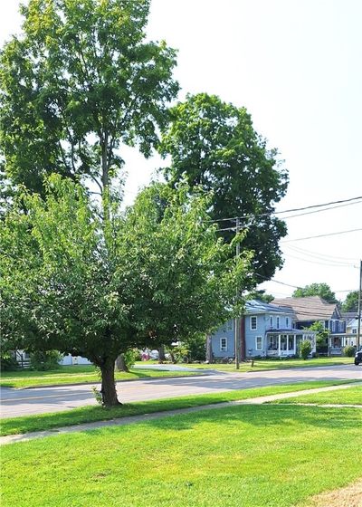 Street view with mature tree and large front lawn | Image 3