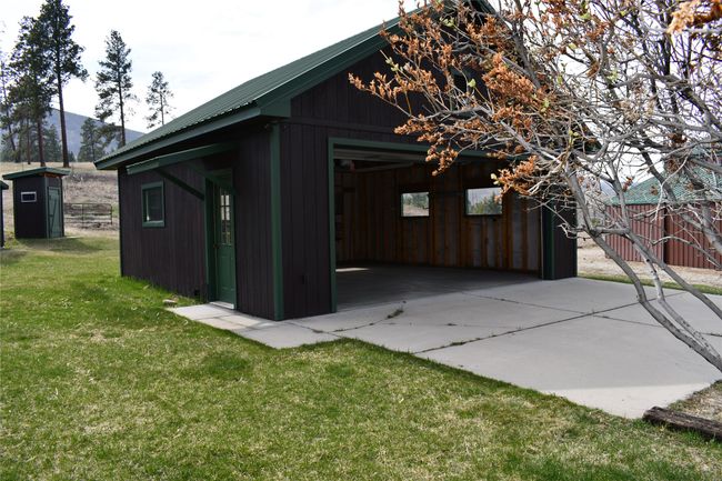Outside view of the two car garage which has a concrete pad on it. | Image 34