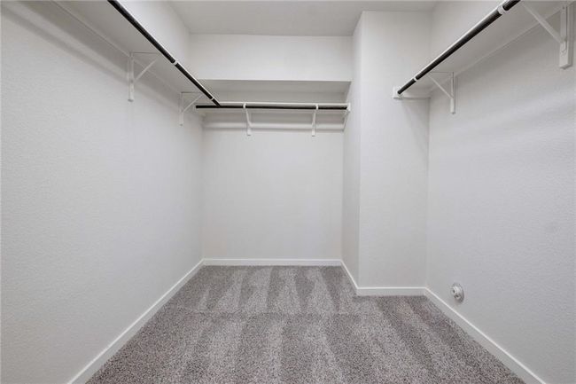 Spacious closet with carpet flooring | Image 15