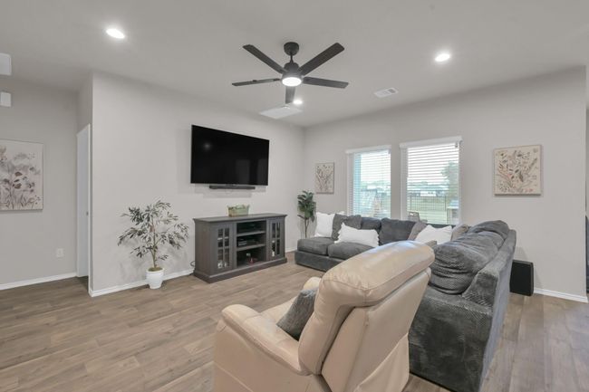 If we head past the stairs we will enter into your oversized living room with the open view into the backyard and lake/greenbelt area. | Image 6