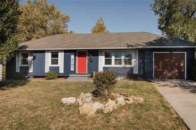 Single story home with a front lawn and a garage | Image 1