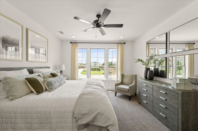 Primary bedroom with a view of the front yard. | Image 5