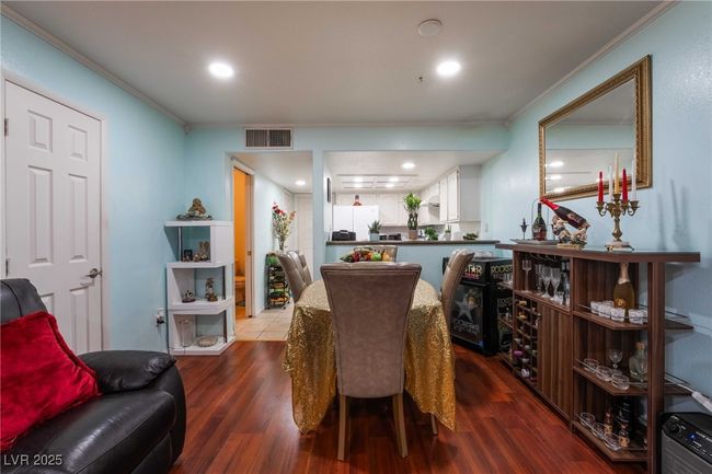 Dining room featuring wood finished floors, visible vents, recessed lighting, and ornamental molding | Image 10