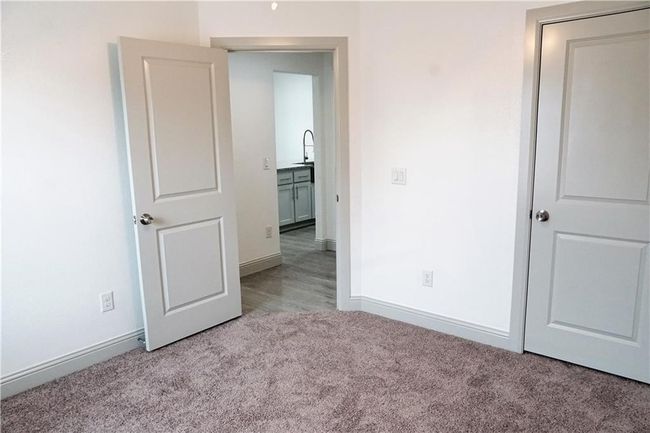 Unfurnished bedroom with carpet flooring and baseboards | Image 10