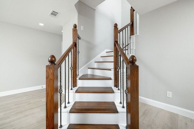 Stairway with wood finished floors and recessed lighting | Image 27