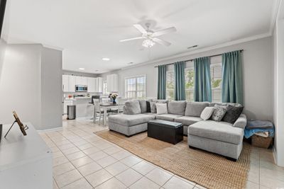 Tiled living room with ornamental molding and ceiling fan | Image 2