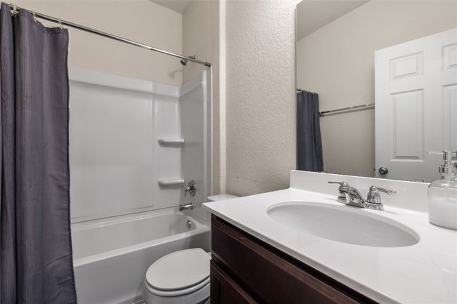 Full bathroom featuring vanity, toilet, and shower / bath combo and linen closet | Image 27
