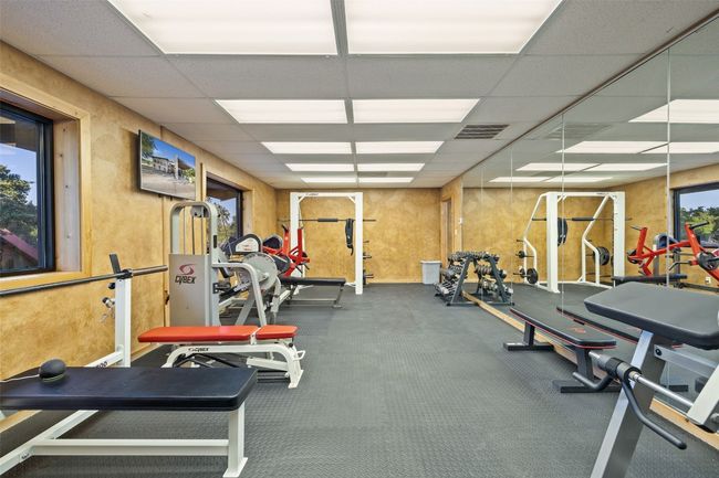 Workout area with a paneled ceiling | Image 33