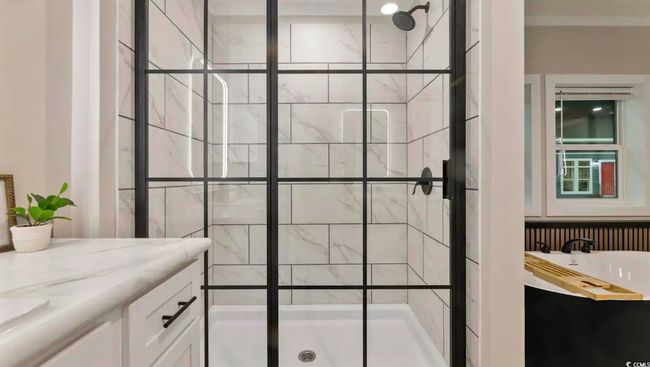 Bathroom with a shower stall and vanity | Image 27