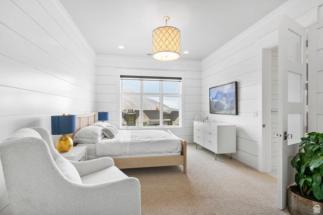 Bedroom featuring ornamental molding, wood walls, recessed lighting, and carpet | Image 45