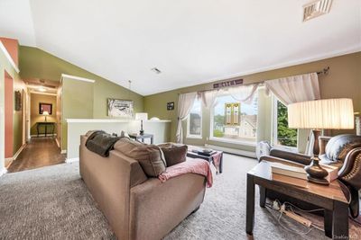 Living room featuring dark hardwood / wood-style floors and vaulted ceiling | Image 3