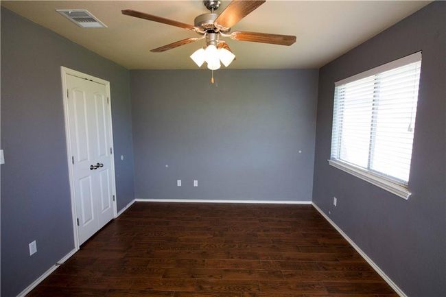 Unfurnished room with a ceiling fan and wood finished floors | Image 6