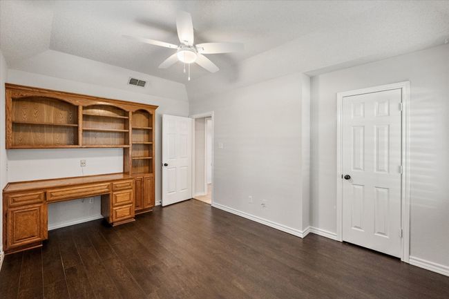 The seller is currently using this room as an office. It could also be a fourth bedroom. The built in desk and book shelves would be a great study area. The ceiling fan was recently updated. It has engineered wood floors, a nice size closet and recent paint. | Image 28