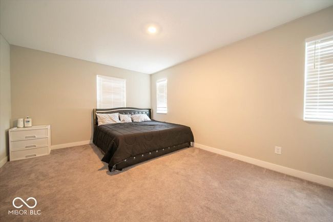 carpeted bedroom featuring multiple windows | Image 23