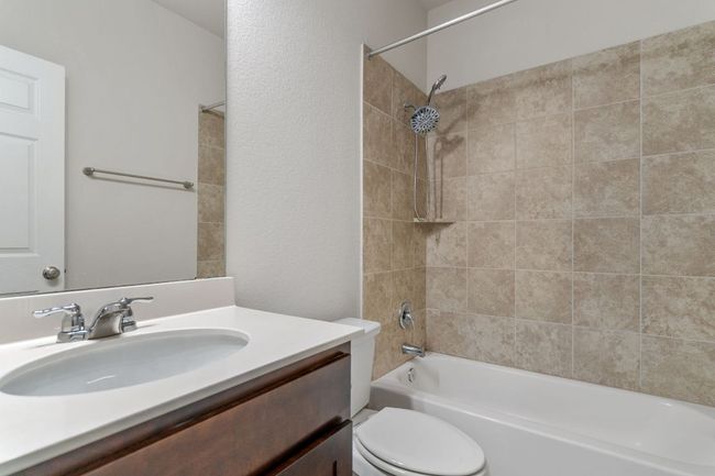 Bathroom featuring toilet, vanity, and washtub / shower combination | Image 32