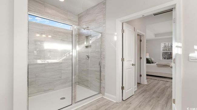 Bathroom featuring wood-type flooring and dual bowl vanity | Image 26