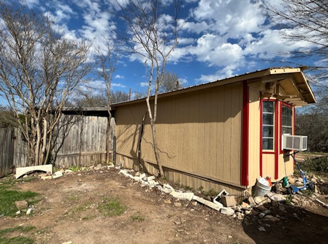 View of side of home featuring an outdoor structure and cooling unit | Image 12