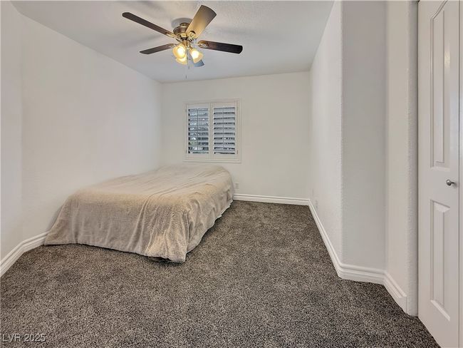 Carpeted bedroom with a ceiling fan and baseboards | Image 34
