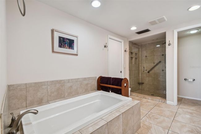 Updated garden tub. Separate shower with large shampoo/soap niches and grab bars. | Image 38