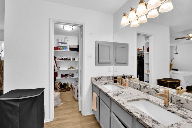 Full bathroom with wood finished floors, double vanity, and a spacious closet | Image 20