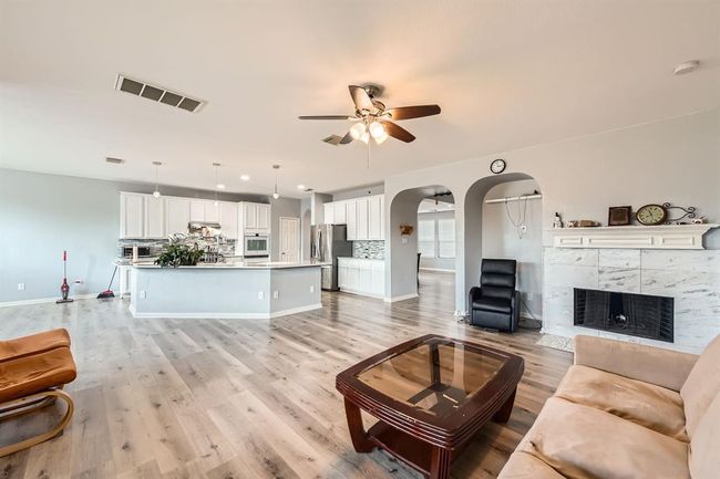 Spacious open-concept living room and kitchen, perfect for modern living and entertaining. | Image 7