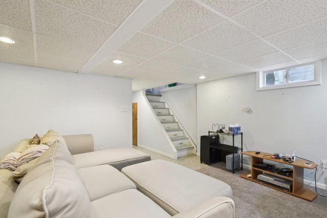 Living room featuring a paneled ceiling and light carpet | Image 26