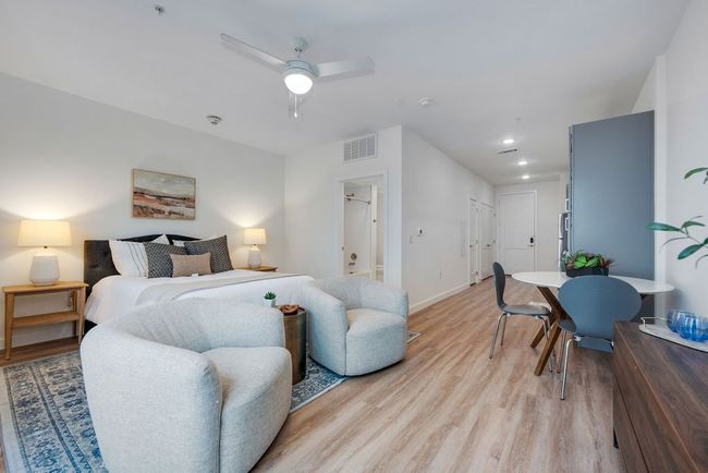 Bedroom featuring light wood-style flooring, baseboards, ceiling fan, recessed lighting, and ensuite bathroom | Image 22