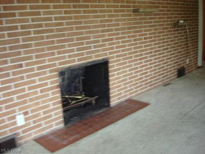 Details featuring carpet flooring and a brick fireplace | Image 3