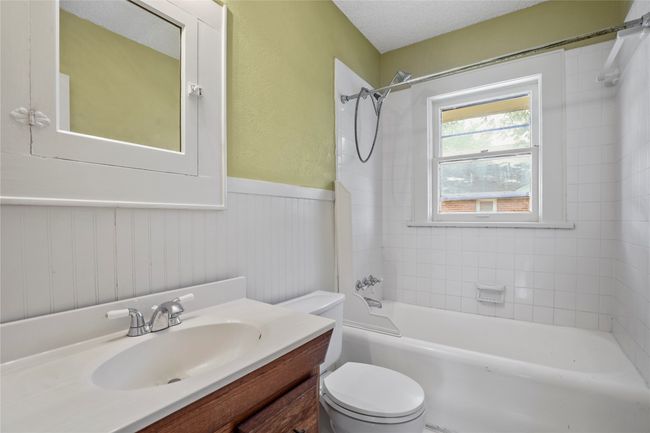 Full bath with toilet, tub / shower combination, a wainscoted wall, and vanity | Image 10
