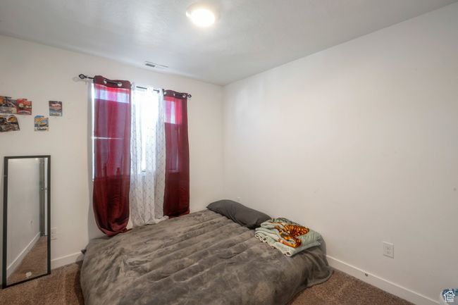 Bedroom with carpet flooring and baseboards | Image 12