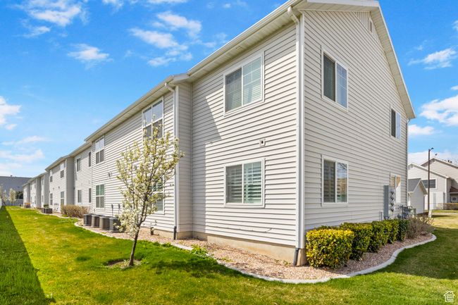 View of home's exterior with cooling unit and a lawn | Image 27