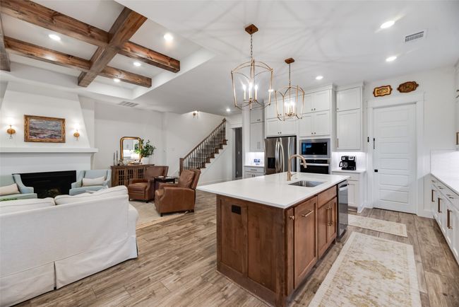 Kitchen with a sink, stainless steel appliances, a chandelier, coffered ceiling, and recessed lighting | Image 15