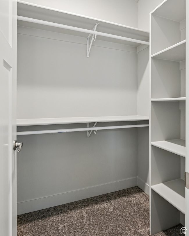 Walk in closet with dark carpet | Image 38