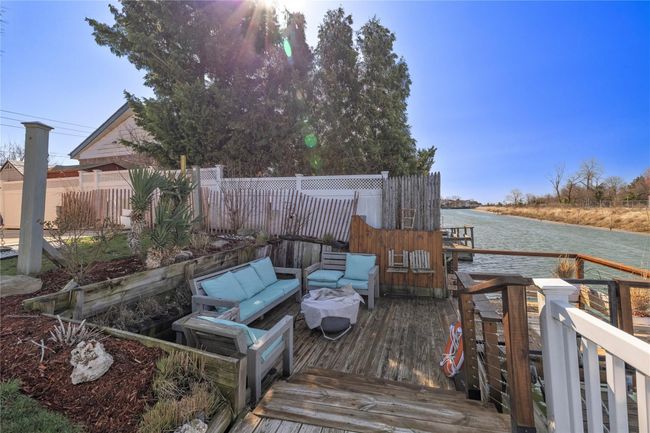 Deck with an outdoor hangout area, a water view, and fence | Image 32