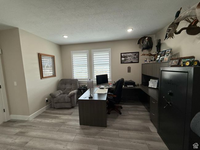 Office with baseboards, light wood-type flooring, recessed lighting, and a textured ceiling | Image 18